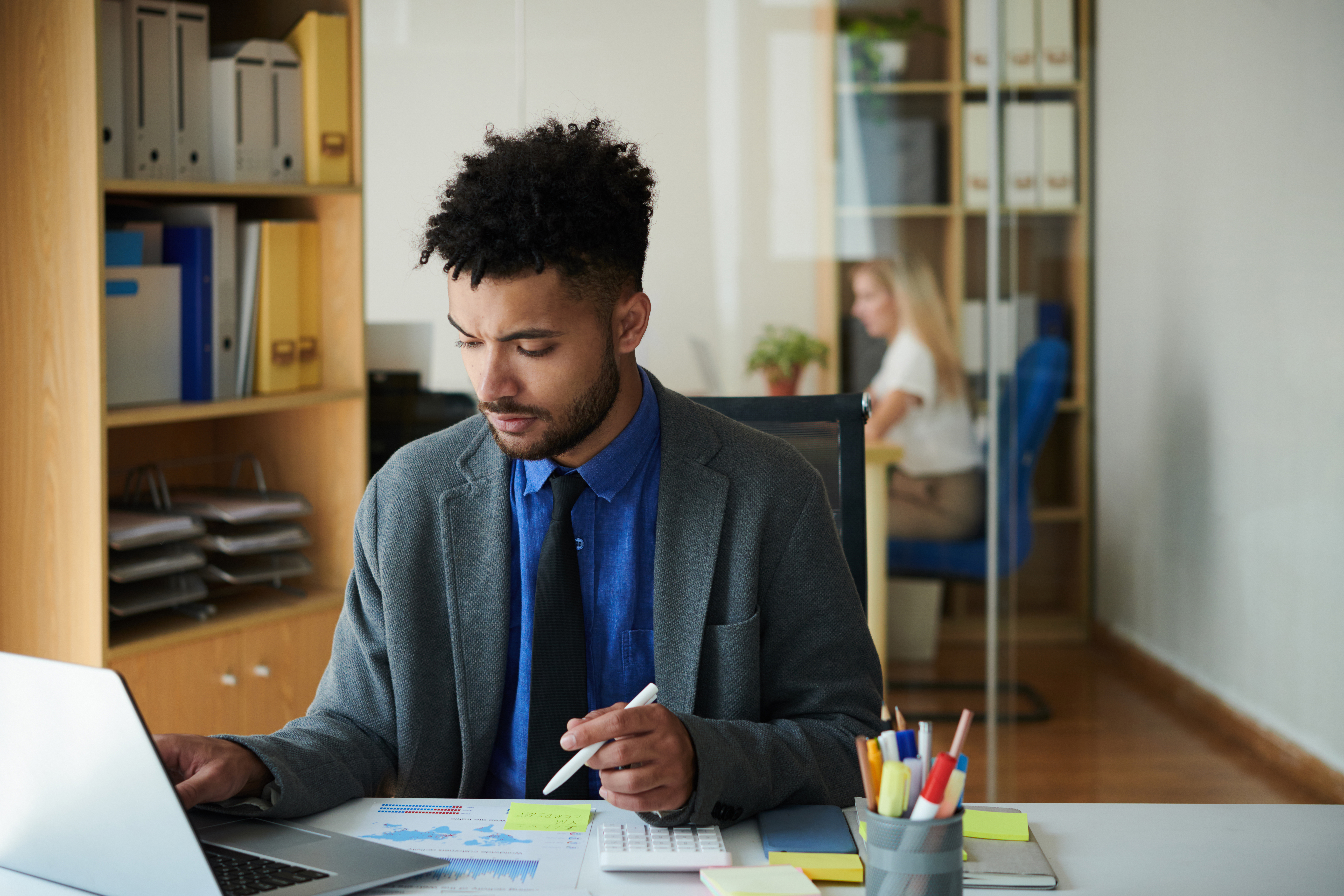 Frowning entrepreneur working on research, analyzing data in marketing report